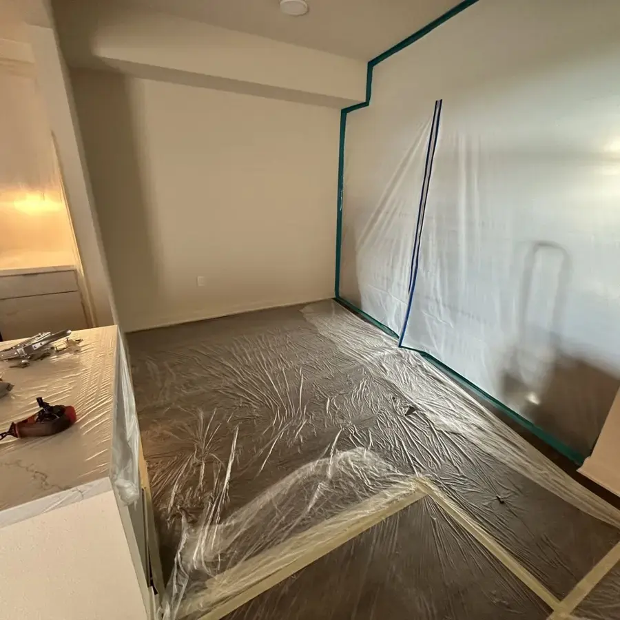 A room sealed in plastic containment during water damage drying