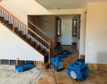 Blue air movers at the foot of a staircase with lower walls cut out in Coronado